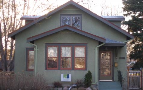 A view of the completed exterior. The dormers which add so much to the upper floor are barely noticed from the street and finished to match the home. Wood storm windows and storm door replaced aluminum storms and give the house a more traditional look. Refinished vintage front door and vintage fixture along with period paint colors are details which enhance the front of the home. 